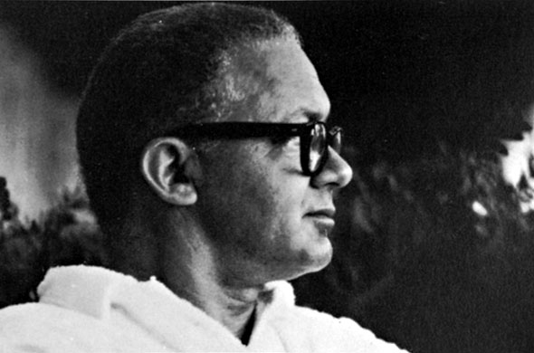 Black and white photograph of a man in profile wearing glasses