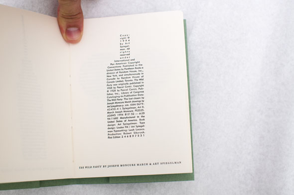 Green book opened to show a block of text shaped like a wine bottle