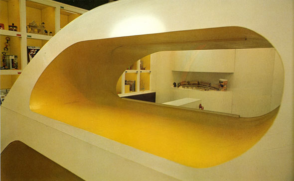 A close up of the curved top for the staircase housing from the front. The holes is yellow and wide enough to serves as a shelf.