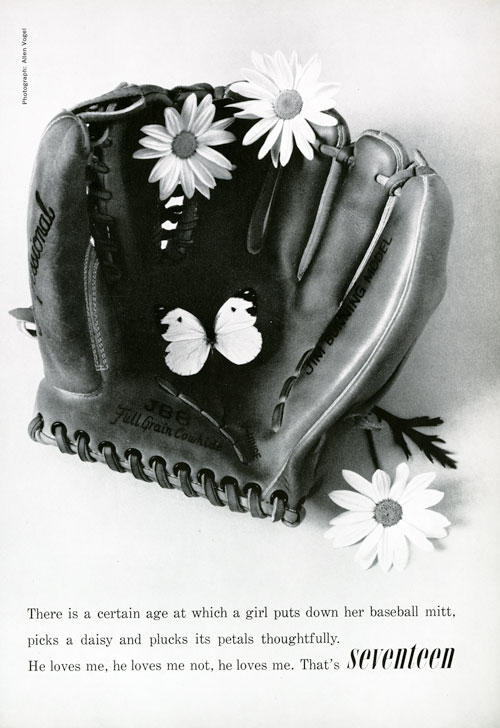 Black and white photo of a baseball mitt with three daisies and a butterfly inside it. Text reads "there is a certain age at which a girl puts own her baseball mitt, picks a daisy and plucks its petals thoughtfully. He loves me, he loves me not, he loves me. That's seventeen