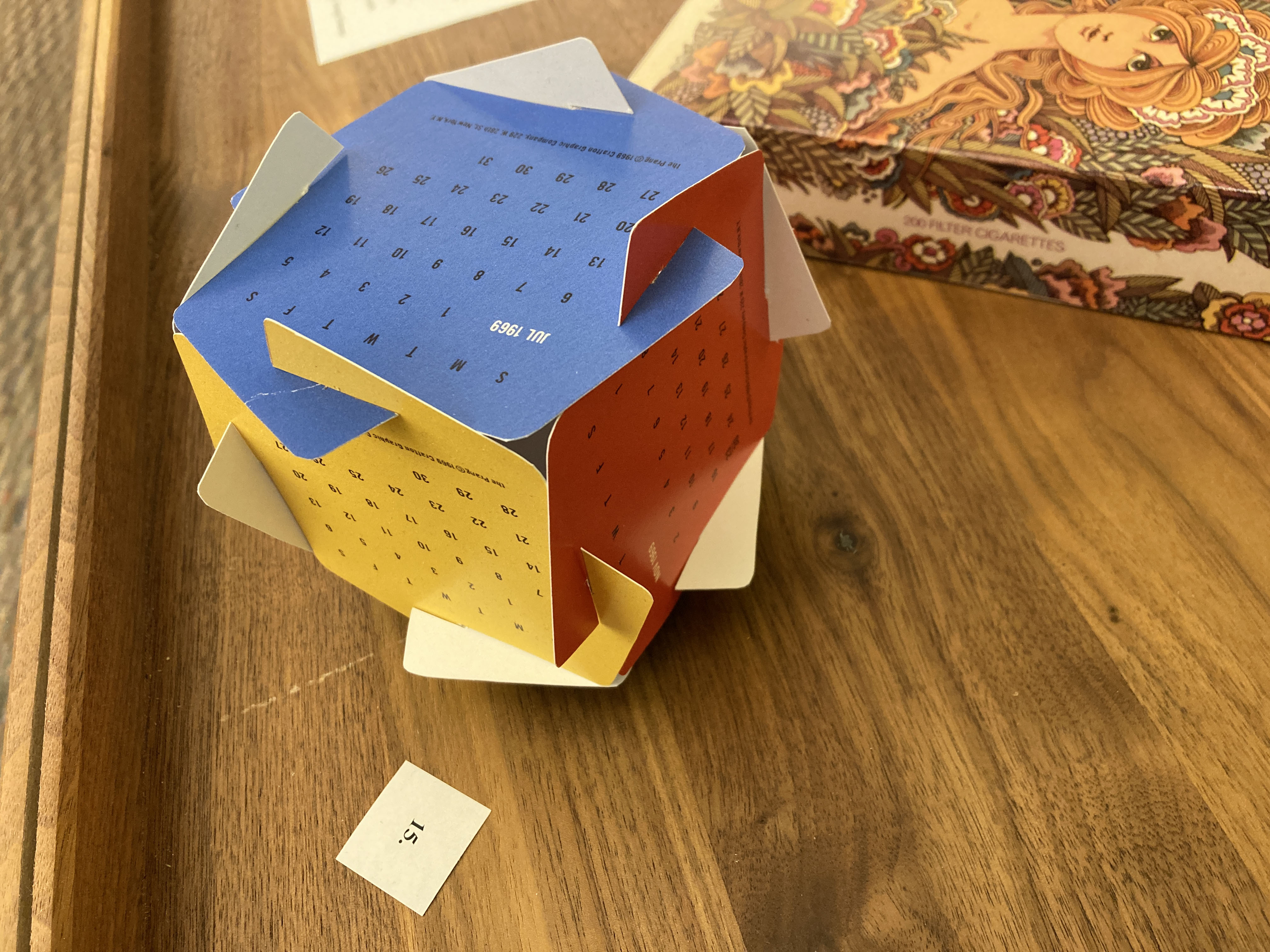 a cube made of six interlocking squares of cardstock, each printed with a calendar month