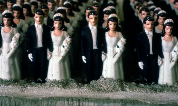 A close up picture of the sculpture used in the movie poster above. The rows of cake toppers are packed neatly and tightly.