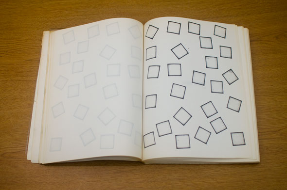 Book spread; left page is blank, right page shows a collection of empty squares