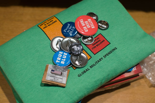 Collection of buttons piled on a green t shirt