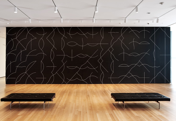 MOMA exhibit of a large, geometric white on black mural.