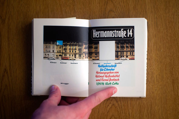 Flipbook opened to show a spread depicting colorful block text and a building