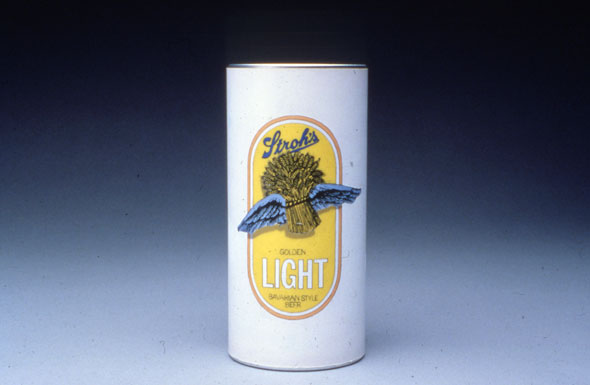 A mostly white small beer can. Very white background with an illustration of a stack of barley tied together with blue wings on it on a bright yellow background with a light pink border.  Underneath the barley is "Golden" in small thin black letter " Light" In big thing white letters". The name of the brand is on top of the barely, "stroh's" is thick scripted blue letters. 