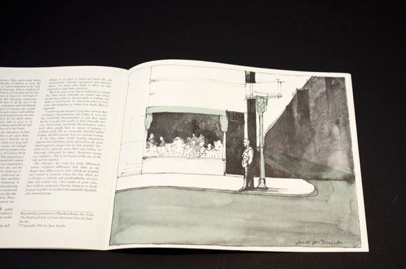 A drawing of a pedestrian waiting at the corner of a street. 