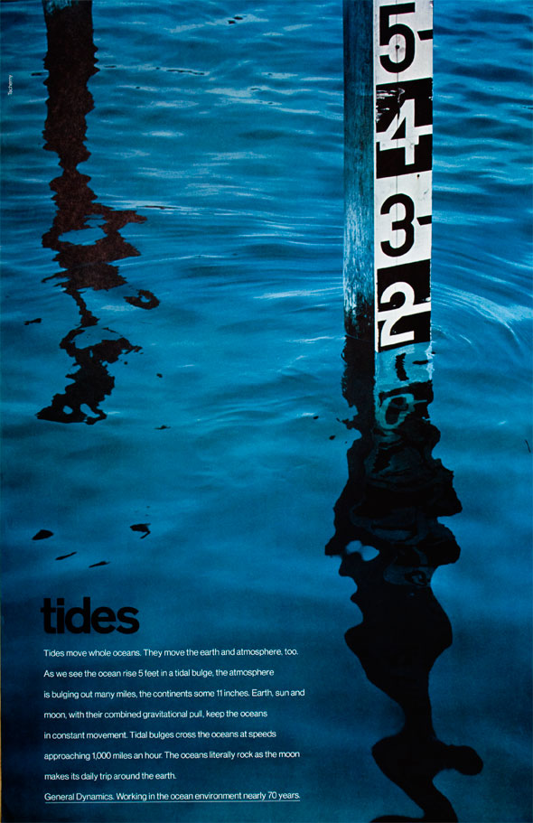 Primarily blue photograph of a measuring post in a body of water