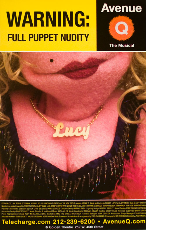 A poster. Color photo of a pink, busty female puppet with red lipstick, long blonde hair, a hot pink feathered boa, and a gold necklace reading Lucy. Header text reads "Warning: Full Puppet Nudity" on a bright yellow background. 