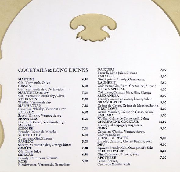 Beige and white cocktail menu decorated with irregular shapes