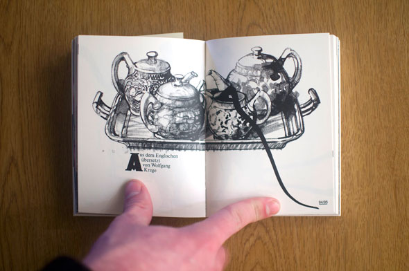 Flipbook opened to show a spread depicting a black and white illustration of four teapots on a tray