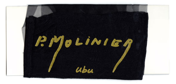 A photo of Black silk stocking wrapped around card; P. Molinier and ubu are written on top in gold