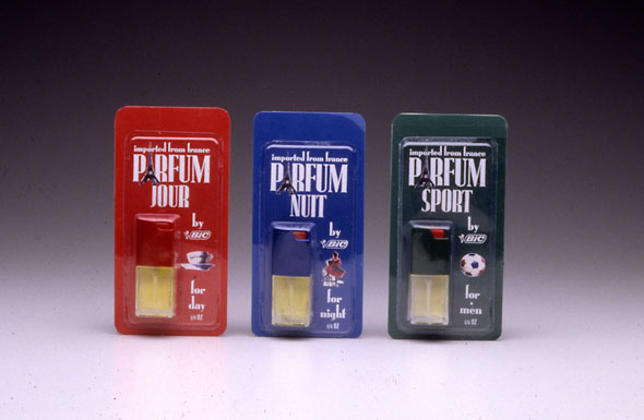 A photo of 3 packages of tiny perfume bottles. All packages has a different colored background with the perfume on the bottom right. Each package has small illustrations correspond to the perfume's purpose next to the perfume. The name of the perfume is on top in white and bolded. The A in "Parfume" is an Eiffel tower. 