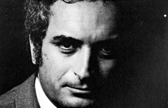 Black and white photograph of a man looking into the camera