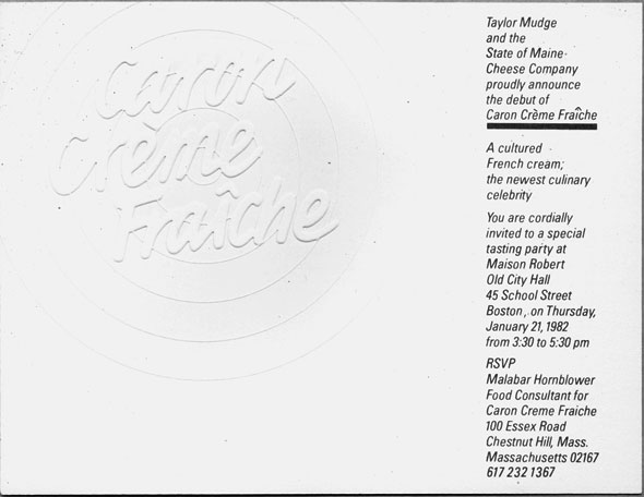 A photo of a White card with a single column of black text down the right side; rest of space is taken up by embossed circular logo with the words Caron Crème Fraîche on top of a target.