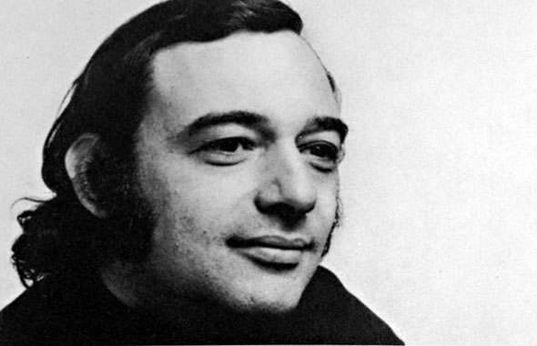 Black and white photograph of a man with sideburns and long hair